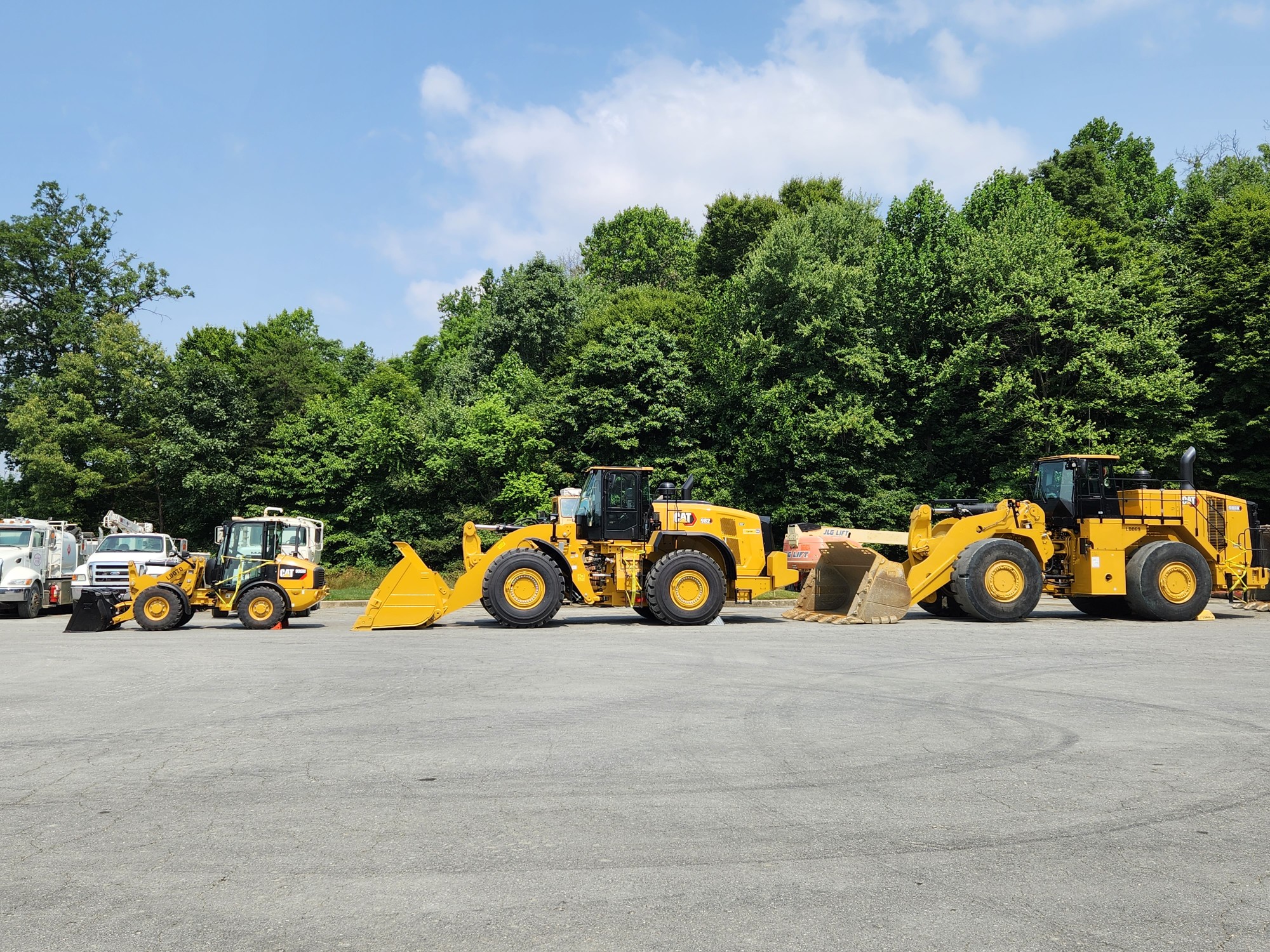 image of construction trucks rolling along the road